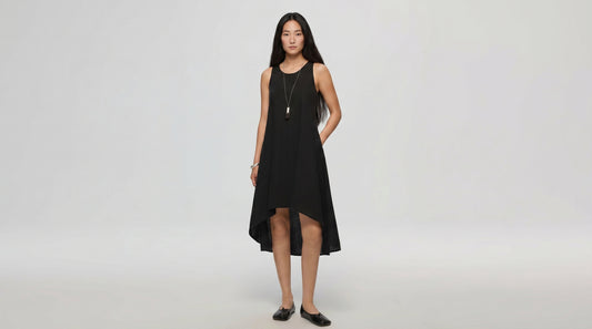 Woman wearing a black dress on a white background