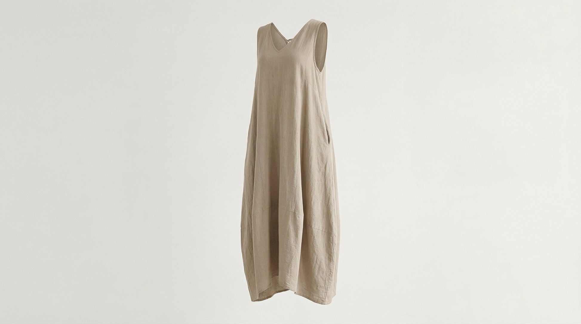 Beige sleeveless dress on a light gray background