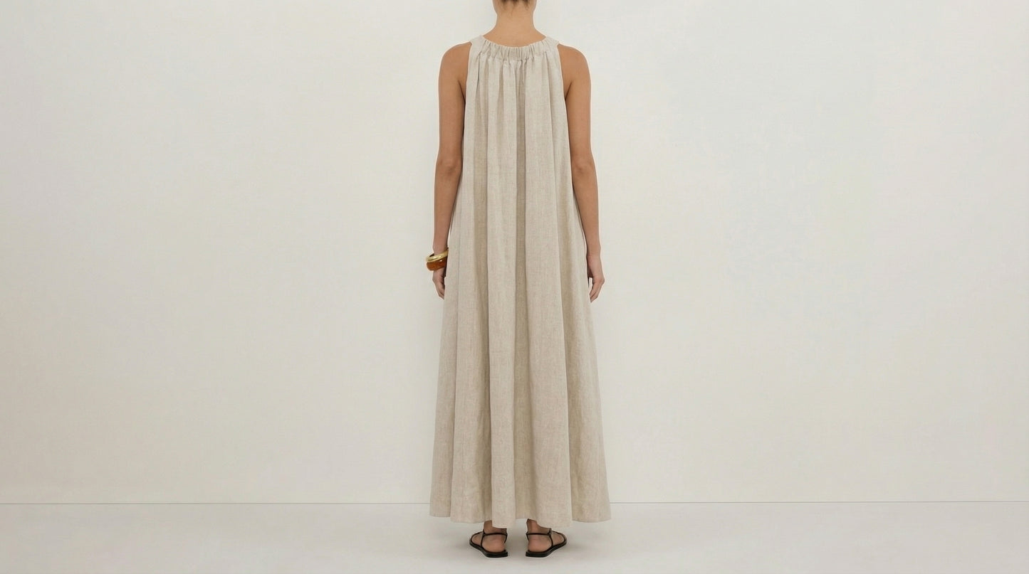 Person wearing a long beige dress on a white background