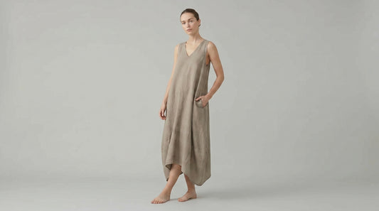 Woman wearing a beige dress against a plain background
