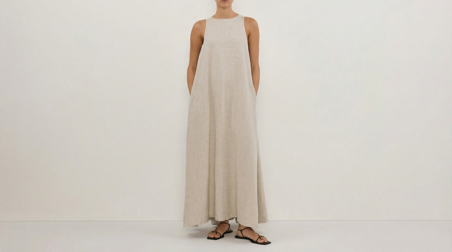 Woman wearing a long beige dress on a white background